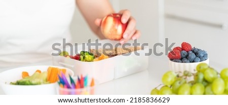Back to school concept - mother making school lunch 