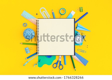 Back to school concept. School notebook and various supplies on yellow background. 