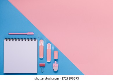 Back to school concept notepad, pencil case, stationery and school supplies. Top horizontal view copyspace pink abstract background