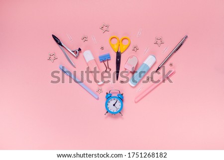 Back to school concept notepad, pencil case, stationery and school supplies. Top horizontal view copyspace pink abstract background
