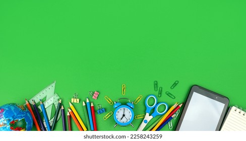 Back to school concept. School and office supplies on a green background. Flat lay. Copy space. - Shutterstock ID 2258243259
