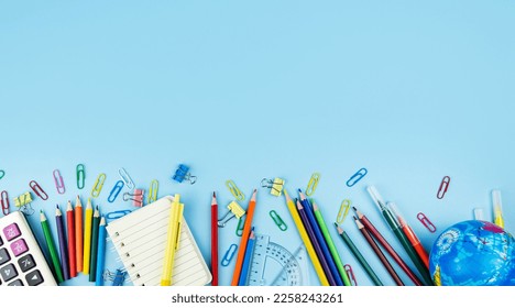 Back to school concept. School and office supplies on a blue background. Flat lay.  Copy space. - Shutterstock ID 2258243261