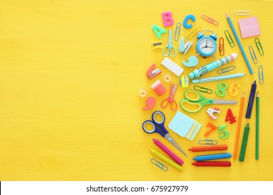 Back to school concept on yellow wooden background. Top view - Powered by Shutterstock