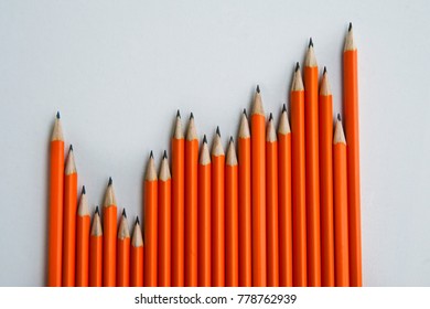 Back To School Concept. A Lot Of Orange Pencils In A Row Over A Table.