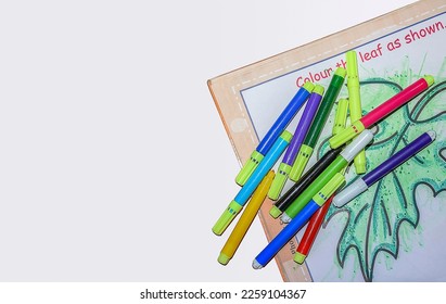 Back to school concept- a Pencil,erasor, sharpner an cut foil of the pencil on white table with or without spectacles not properly aranged isolated.