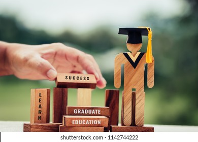 Back to School Concept, People Sign wood with Graduation celebrating cap on wooden square blocks tower blur hands. Space for letter e.g education, graduate, learn. Ideas for international Educational