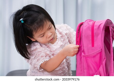 Back to school concept. Pupil child are zipping her bags to prepare her belongings before starting school again. Children are excited to go to school.