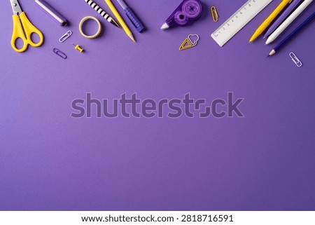 Back to school concept with purple background and yellow-accented stationery including pencil, scissors, ruler and paper, ideal for study, classroom projects, creative workspace and school supplies