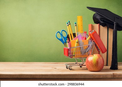 Back To School Concept With Shopping Cart, Books And Graduation Hat