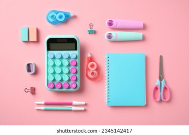 Back to school concept. School supplies on pastel pink background. Flat lay, top view calculator, paper notebook, scissors, pens, sharpeners, erasers, markers - Powered by Shutterstock