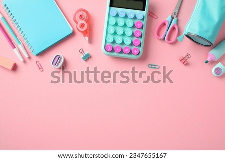 Back to school concept. School supplies on pastel pink background. Flat lay composition with calculator, paper notebook, scissors, pencils, case, sharpeners, erasers