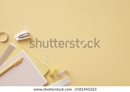 Back to school concept. Top view photo of stationery diaries pen ruler clips mini stapler and adhesive tape on isolated pastel yellow background with copyspace