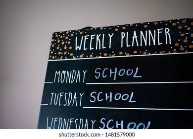 Back To School Concept. School Wrote On A Black Board In Chalk Saying That Monday Through To Friday Is School Days. Space On Isolated White Background For Copy Space.