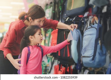 Back To School Concept, Young Asian Mother Or Parent And Little Girl Kid  Buying School Satchel Or Bag In Store, Selective Focus