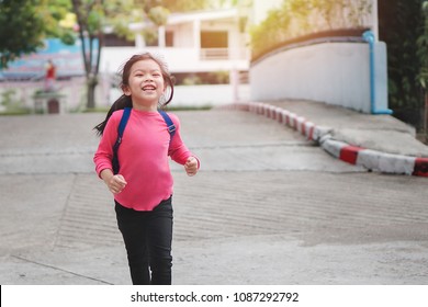 Back To School Concept, Young Asian Cute Kid Or Pupil Running Into School At Morning, Selective Focus.