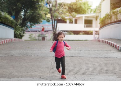 Back To School Concept, Young Asian Cute Kid Or Pupil Running Into School At Morning, Selective Focus.