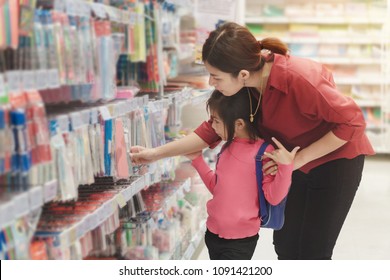 Back To School Concept, Young Asian Mother Or Parent And Little Girl Or Pupil Buying School Supplies In Store, Selective Focus