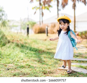 Back To School Concept.Happy Funny Little Toddler Asian Girl With Big Smile And Very Excited And Glad When She Go Back To School.Child From Elementary School Kindergarten With Bag.Education Concept.