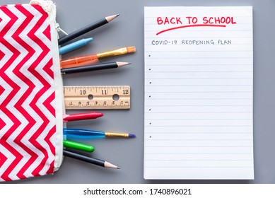 Back To School COVID-19 School Reopening Plan Concept Shot. Flay Lay Arrangement With School Supplies