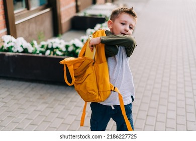 Back To School. Cute Child Packing Backpack, Holding Notepad And Training Books Going To School. Boy Pupil With Bag. Elementary School Student Going To Classes. Kid Walking Outdoor On The City