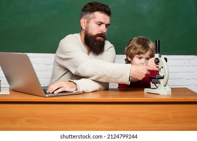 Back To School. Dad Son Are Concentrated On The Problem. First Day In School. Copy Space. Child Learning. Chalkboard Ready For Text. Man Teaches Child. Chalkboard Background.