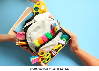 Back to school donation drive concept. Top view cardboard box with backpack full of colorful school supplies. - Powered by Shutterstock