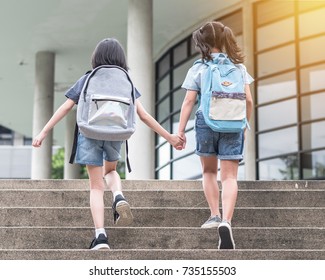 Back To School Education Concept With Girl Kids (elementary Students) Carrying Backpacks Going To Class On School First Day Holding Hand In Hand Together Walking Up Building Stair Happily