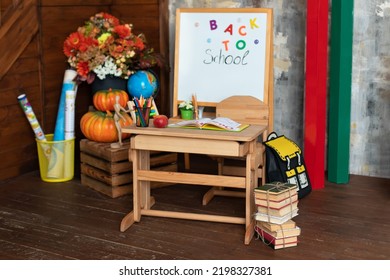 Back To School. Empty Classroom With Blackboard And Wooden Table. Kindergarten. Interior Of Elementary School. Chalkboard, Backpack, Pencils And Stationery On Classroom. Teachers Day. 