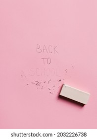 Back to school erased note on a pastel pink background. Creative school concept. Flat lay, top view.