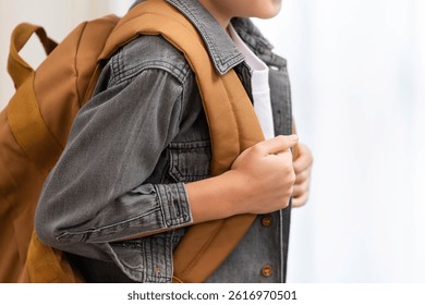Back to School Essentials. A child preparing for school with a stylish backpack.