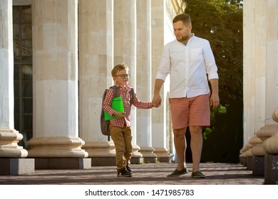 Back To School. Father Leaves Child In School Building. First Day Of Fall. Dad Saying Goodbye To Son. Parent Leads Child To Study. 