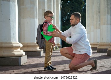 Back To School. Father Leaves Child In School Building. First Day Of Fall. Dad Saying Goodbye To Son. Parent Leads Child To Study. 