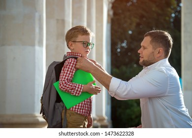 Back To School. Father Leaves Child In School Building. First Day Of Fall. Dad Saying Goodbye To Son. Parent Leads Child To Study. 