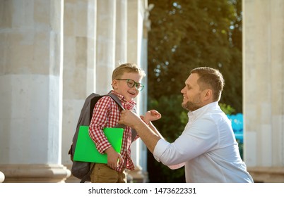 Back To School. Father Leaves Child In School Building. First Day Of Fall. Dad Saying Goodbye To Son. Parent Leads Child To Study. 