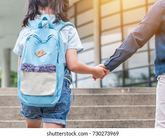 Back To School First Day Education Concept With Girl Kid (elementary Student) Carrying Backpacks Holding Parent Woman Or Mother's Hand Walking Up School Building Stair Going To Class