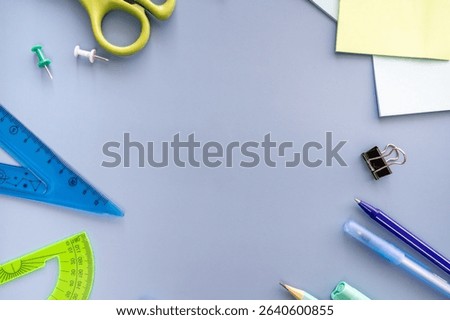 Back to school.  Flat lay. Blue background with stationery.  Space for text