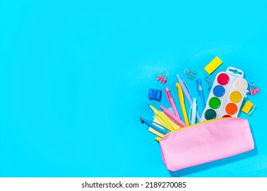 Back To School Flatlay Background. Pink Pencil Case With Various School Stationery On High-colored Bright Background