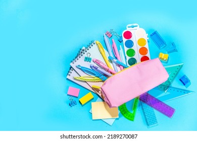 Back To School Flatlay Background. Pink Pencil Case With Various School Stationery On High-colored Bright Background