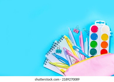 Back To School Flatlay Background. Pink Pencil Case With Various School Stationery On High-colored Bright Background