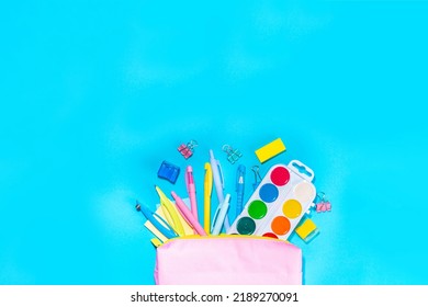 Back To School Flatlay Background. Pink Pencil Case With Various School Stationery On High-colored Bright Background