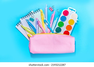 Back To School Flatlay Background. Pink Pencil Case With Various School Stationery On High-colored Bright Background