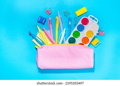 Back To School Flatlay Background. Pink Pencil Case With Various School Stationery On High-colored Bright Background