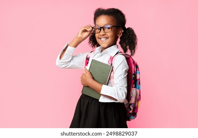 Back To School. Happy Afro Elementary Student Girl Holding Books Smiling At Camera On Yellow Studio Background. Free Space - Powered by Shutterstock