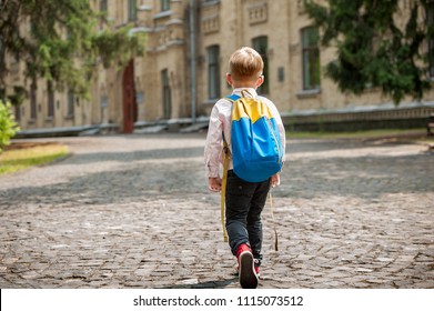 Back To School. Happy Boy Is Going To School For The First Time. Child With Backpack And Book Outdoors. Beginning Of Lessons.  First Day Of Fall. Back View.