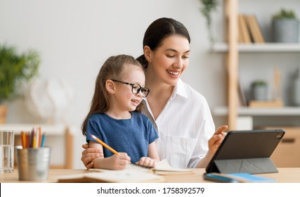 Back To School. Happy Child And Adult Are Sitting At Desk. Girl Doing Homework Or Online Education.