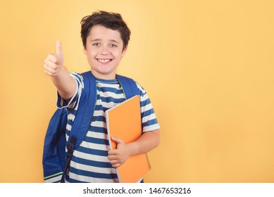 back to school, happy child with backpack and notebook against yellow background - Shutterstock ID 1467653216
