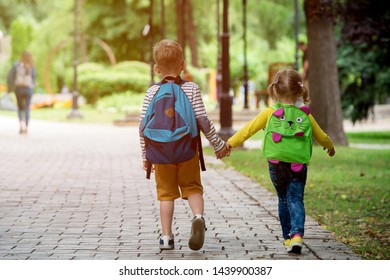 Back To School. Happy Children Ready For Primary School. Pupil On First Day Of Classes. Boy And Girl In Glasses With Backpack And Book On Backyard. Education For Kindergarten And Preschool Kids.