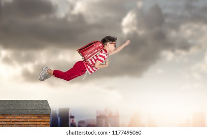 Back to school! Happy cute industrious child flying on sunset sky. Concept of education and school. 