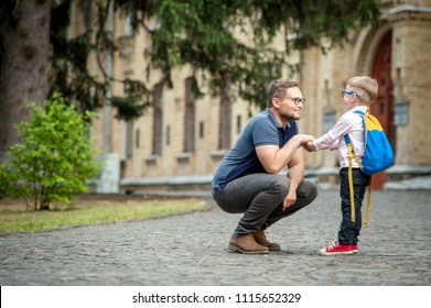 Back To School.  Happy Father And Son Go To Elementary School. Parent Taking Child To Primary School. Pupil Go Study With Backpack. Beginning Of Lessons.  First Day Of Fall. 