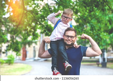 Back To School. Happy Father And Son Go To Elementary School. Parent Take Child To Primary School. Pupil Go Study With Backpack. Beginning Of Lessons. First Day Of Fall.